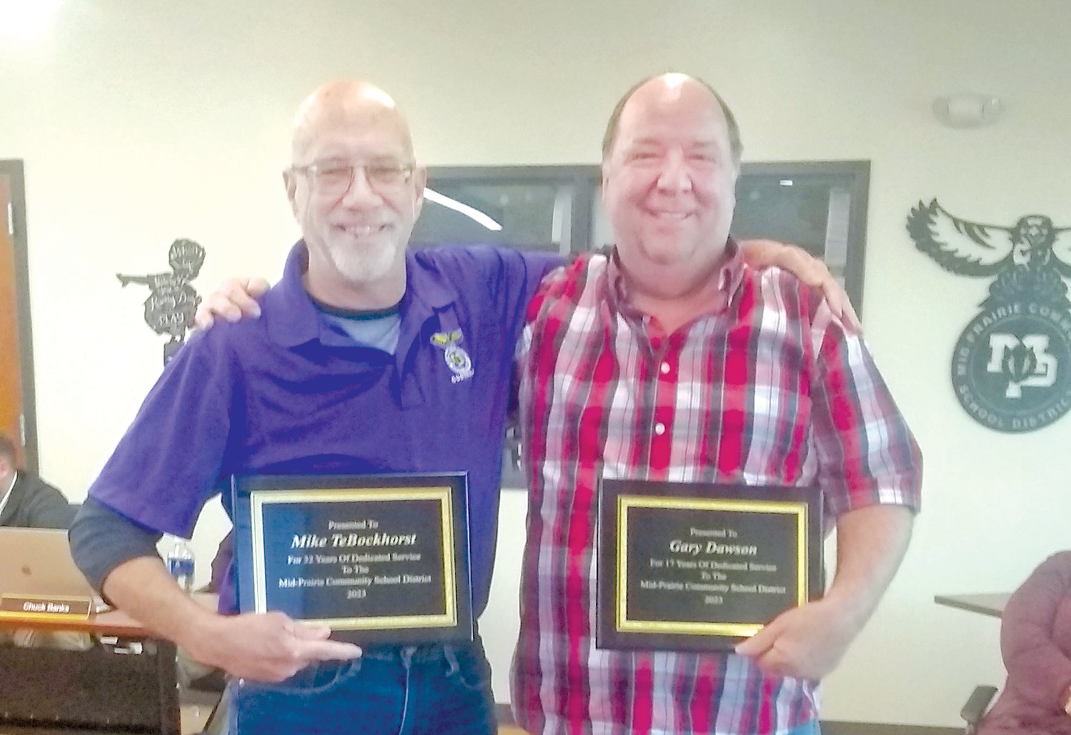Lead Custodians Mike TeBockhorst, left, and Gary Dawson, received plaques commemorating their years of service from the Mid-Prairie Community School District on March 28.